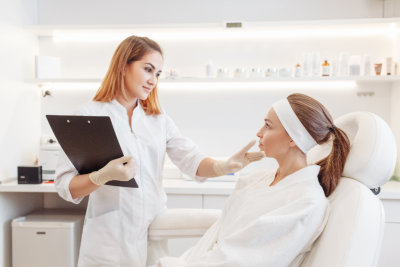 dermatologist examining a woman's face