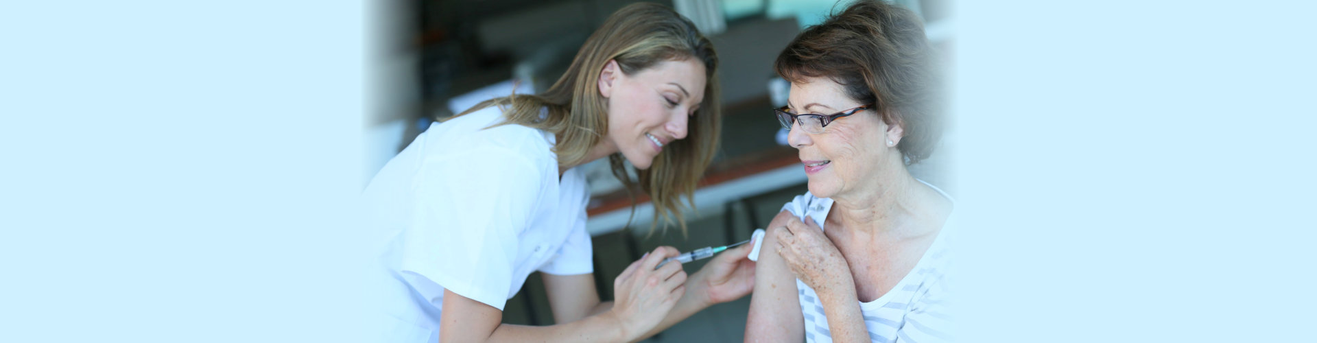 Senior woman receiving flu vaccine